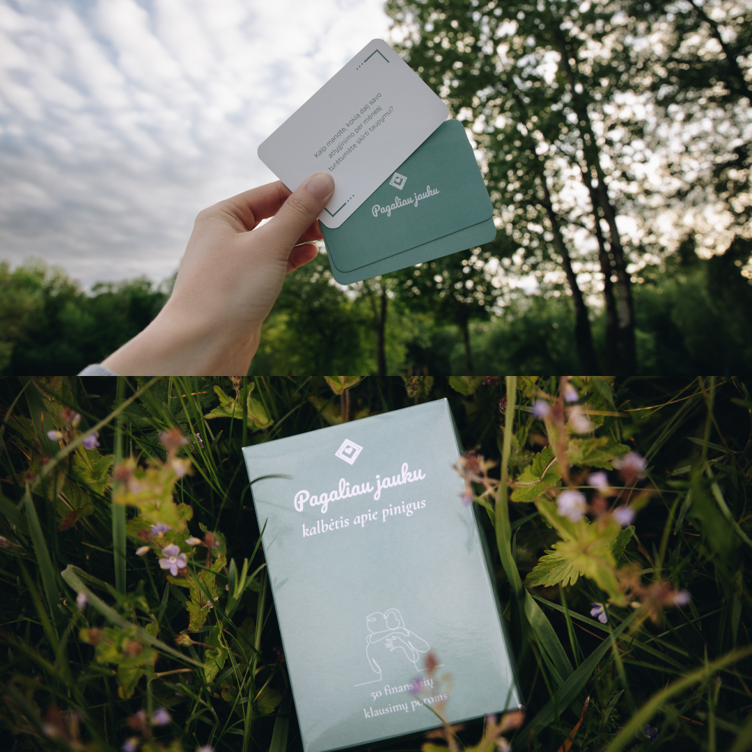 Hand holding a green card with text against a natural background of trees and grass.